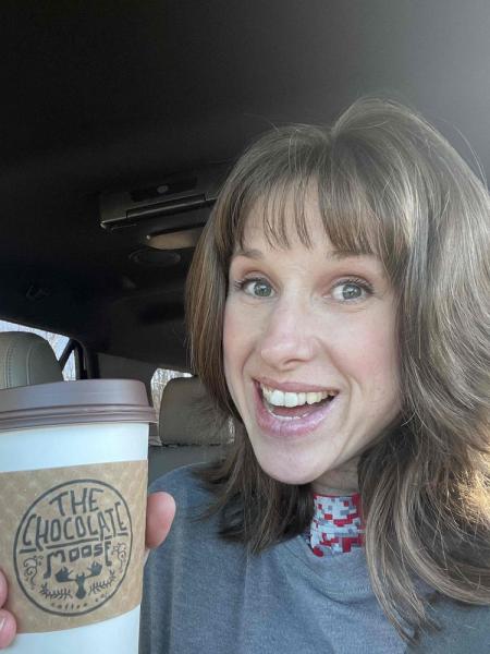 Lena Picha holding Chocolate Moose coffee cup