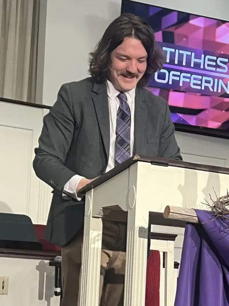 Pastor David Bush at pulpit smiling